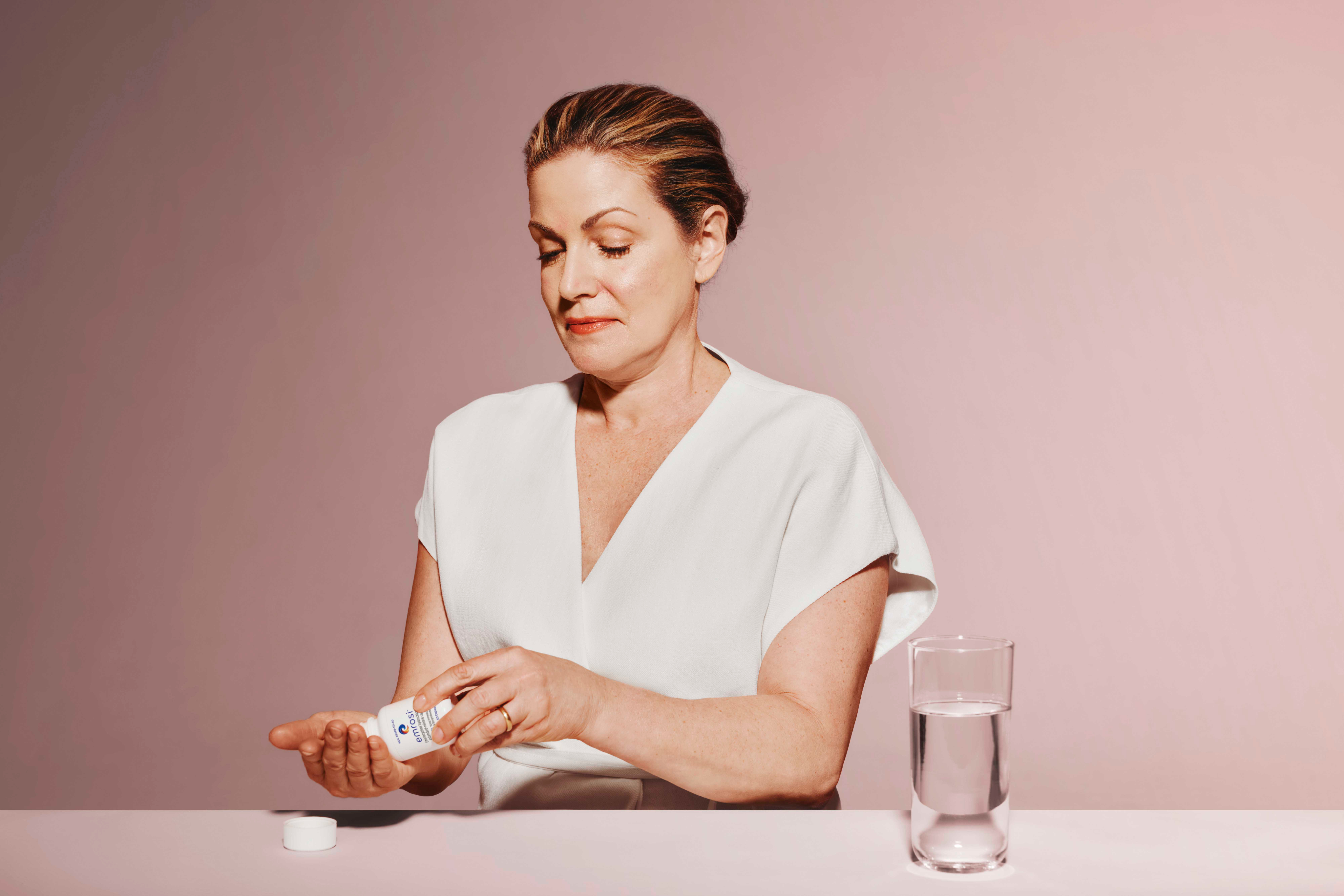 Emrosi patient applying skincare in a sunlit setting